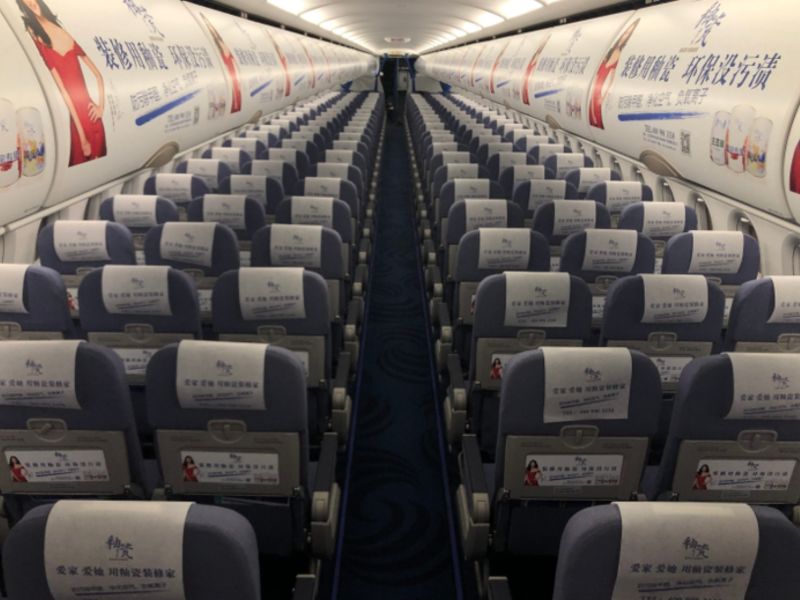 Advertisement for headrest scarves in the cabin of China Southern Airlines aircraft